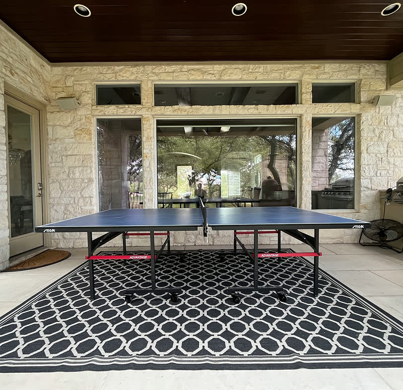 A ping pong paddle and ball